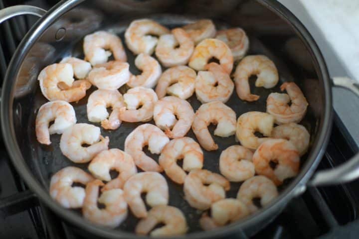 sautéed shrimp in a pan.