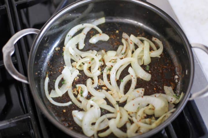 Onions, garlic and spices in a pan with olive oil. Sautéing.