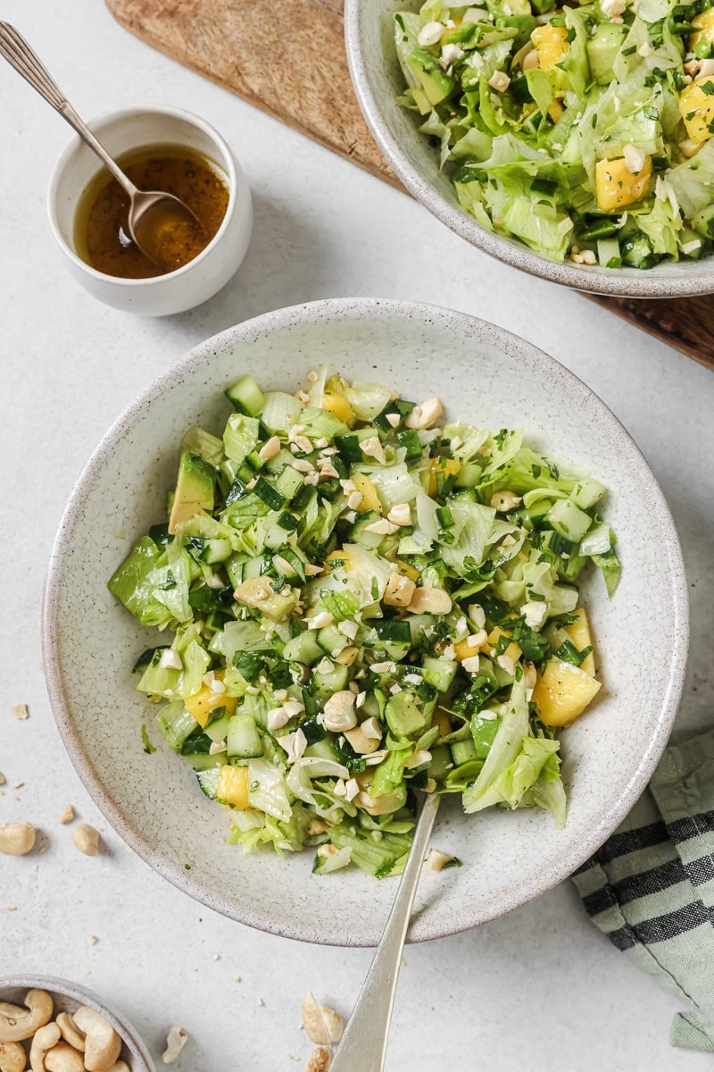 chopped mango salad with dressing in a bowl. 