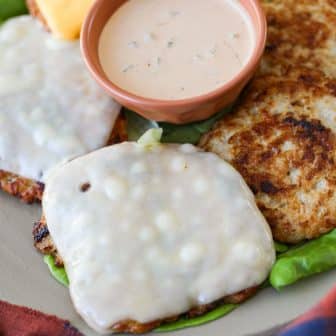up close picture of burgers with cheese.