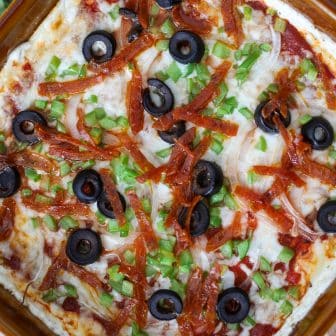 pizza dip served hot with toppings and cheese.