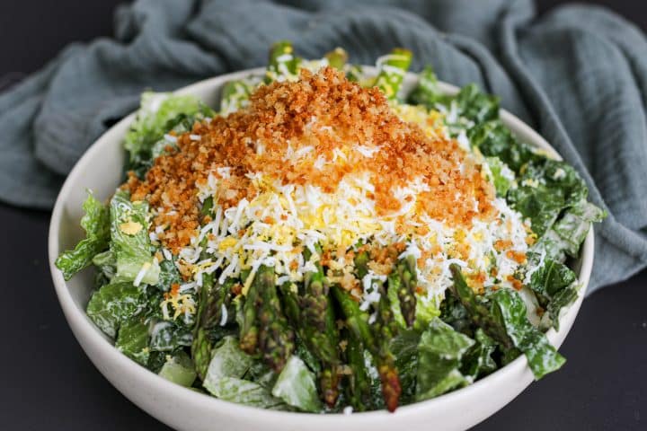 Ultimate Caesar Salad in a bowl with toppings.