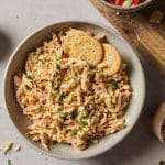 buffalo chicken salad in a bowl with cracker on the side.