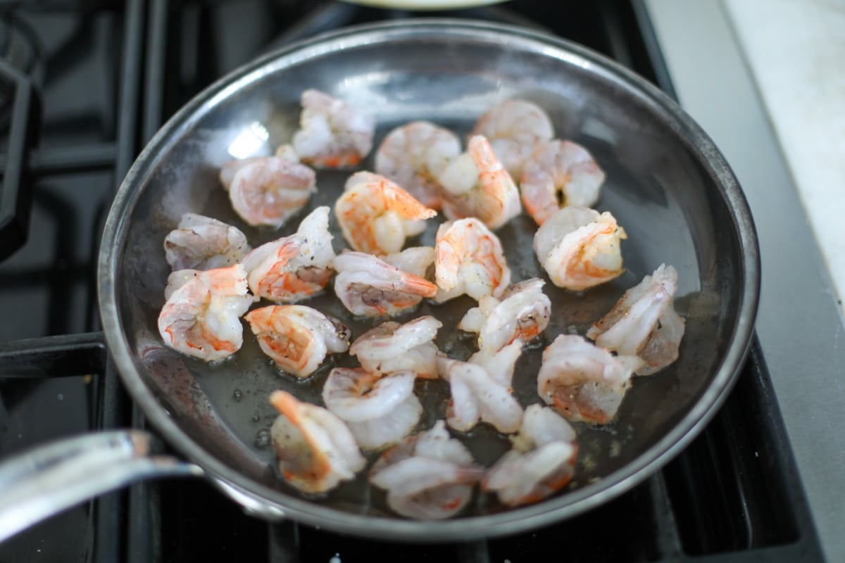 shrimp sautéing in a pan. 