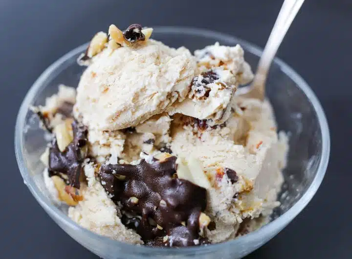 Snickers inspired cottage cheese ice cream in a glass bowl.