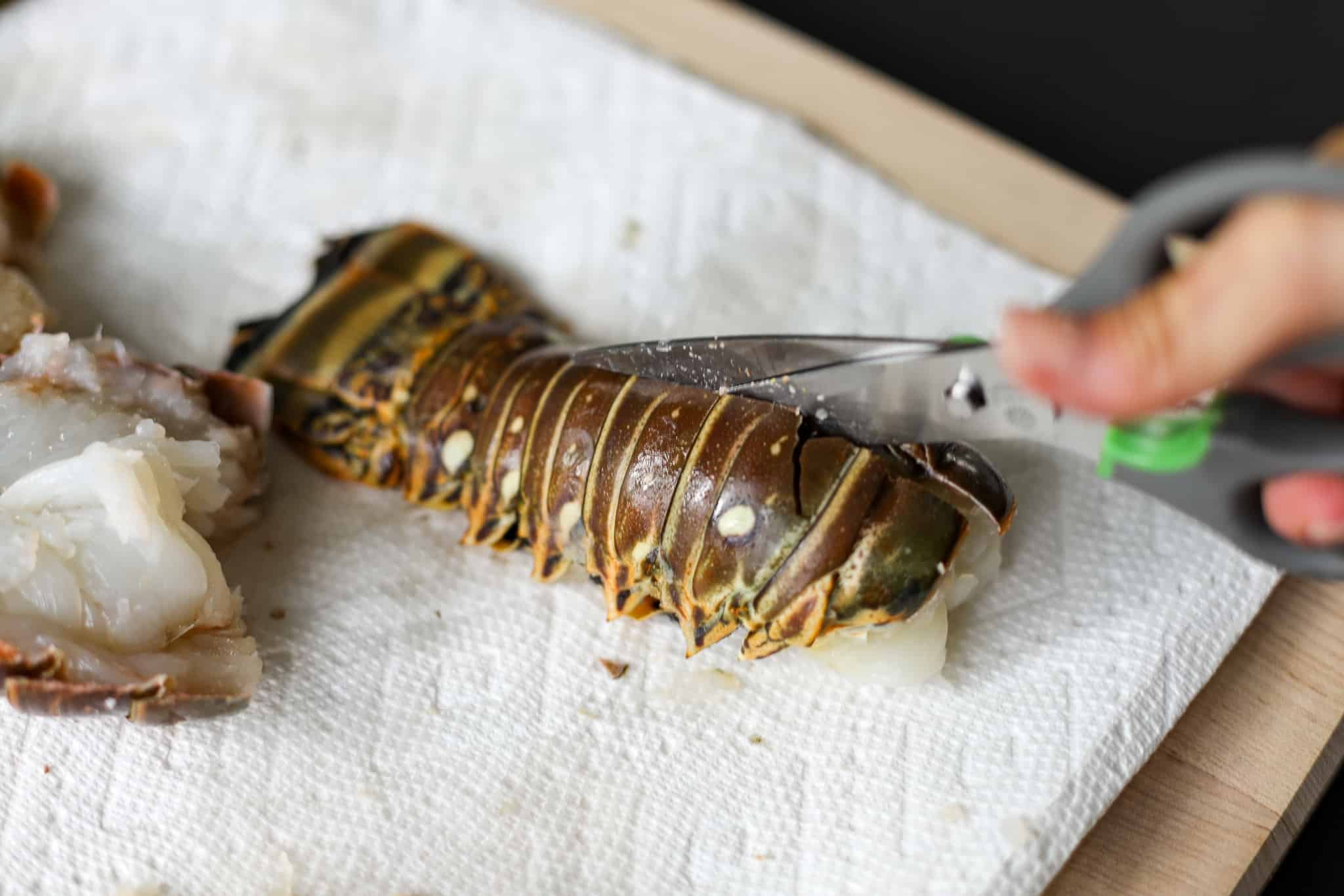 Cutting the lobster tail shell with kitchen shears - Grilled Lobster Tails Recipe - Healthyish Foods