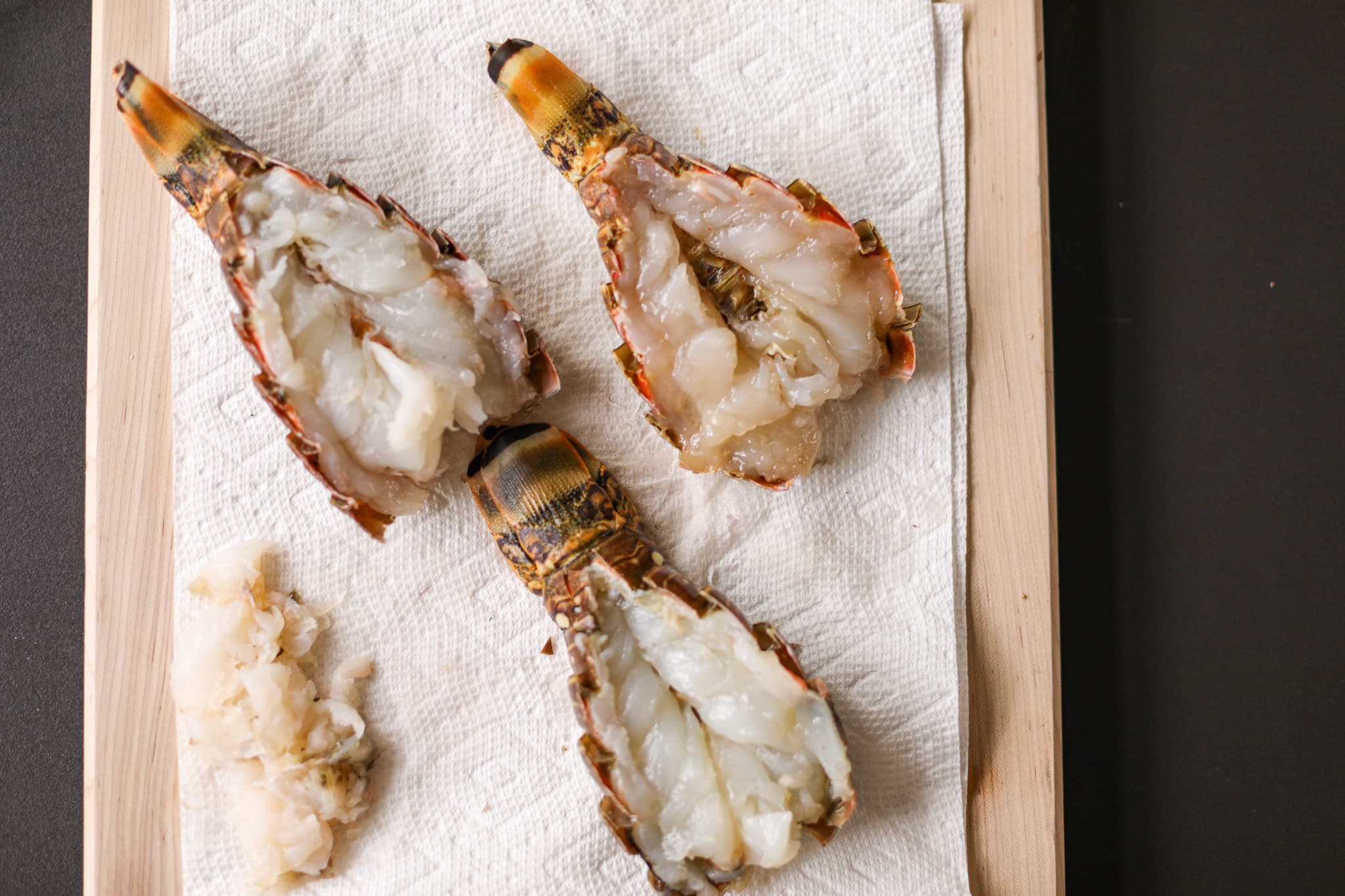 Prepared lobster tails before grilling.