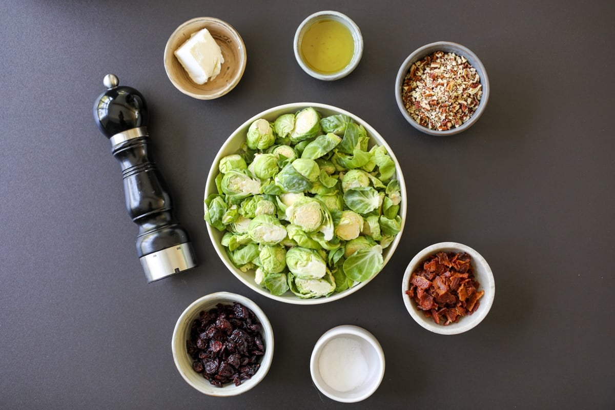 ingredients needed for Brussels sprouts with bacon, pecans, cranberries and goat cheese.