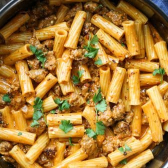 close up shot of the sun-dried tomato pesto sausage pasta in a pan.