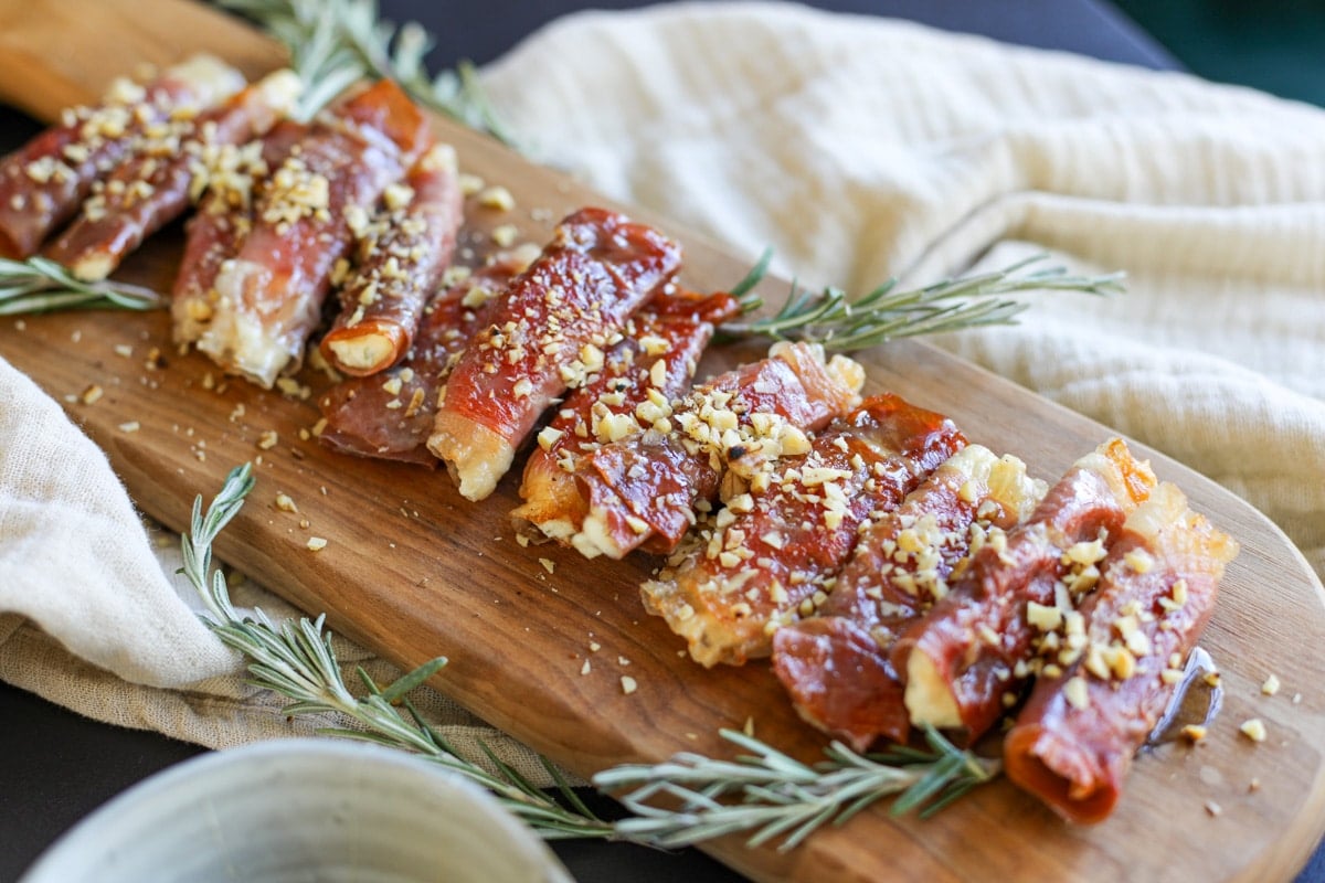 Crispy Prosciutto Wrapped Boursin Cheese with honey and nuts.