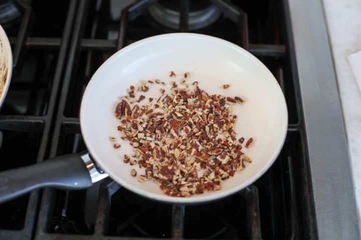 pecans toasting in a pan. 