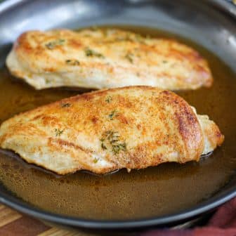 chicken breasts seared in pan.