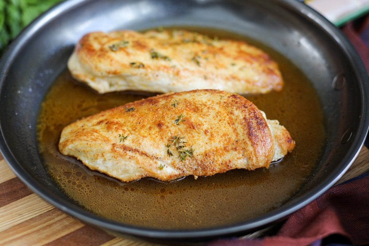 chicken breasts seared in pan.