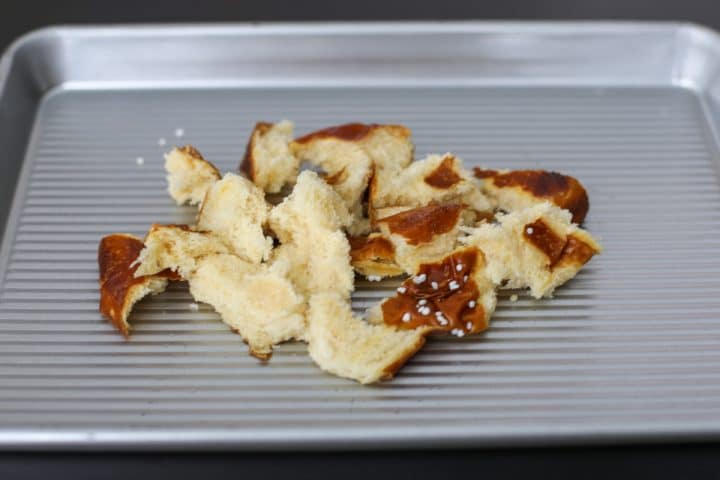 tor pretzel roll on a baking tray.