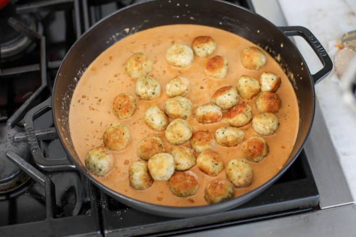 chicken meatballs nestled in sauce.