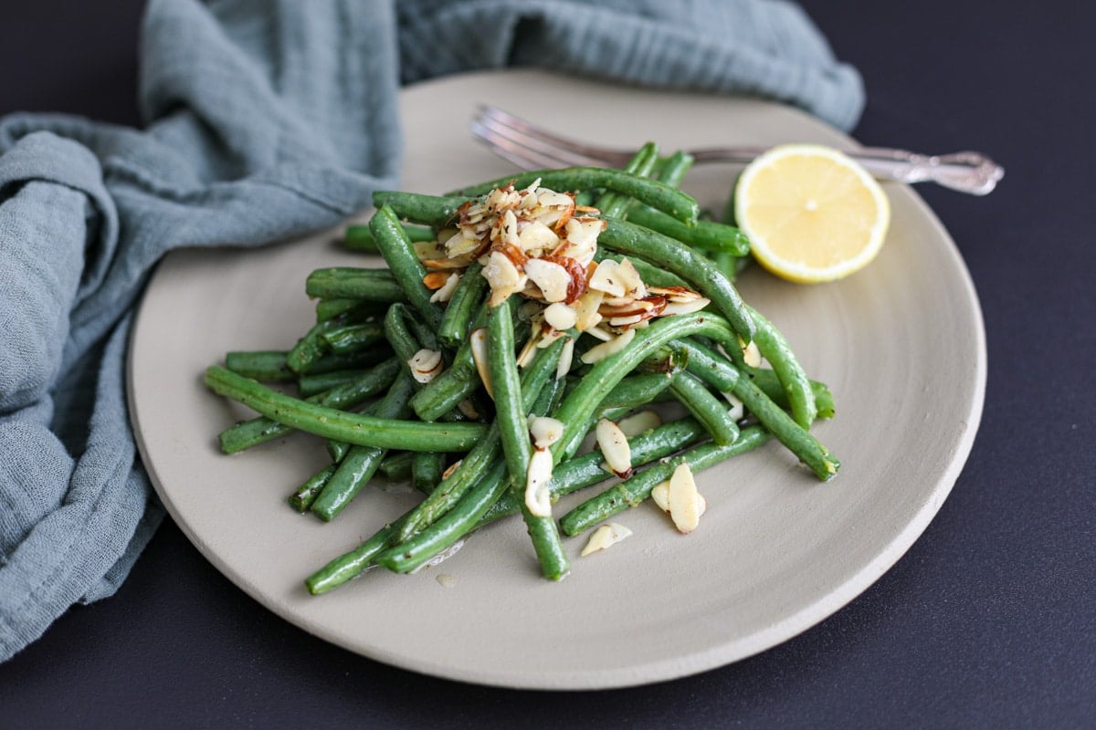 green beans plated with lemon.