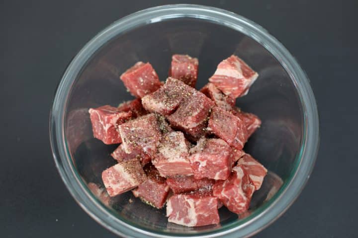 seasoned steak cubes in a bowl.