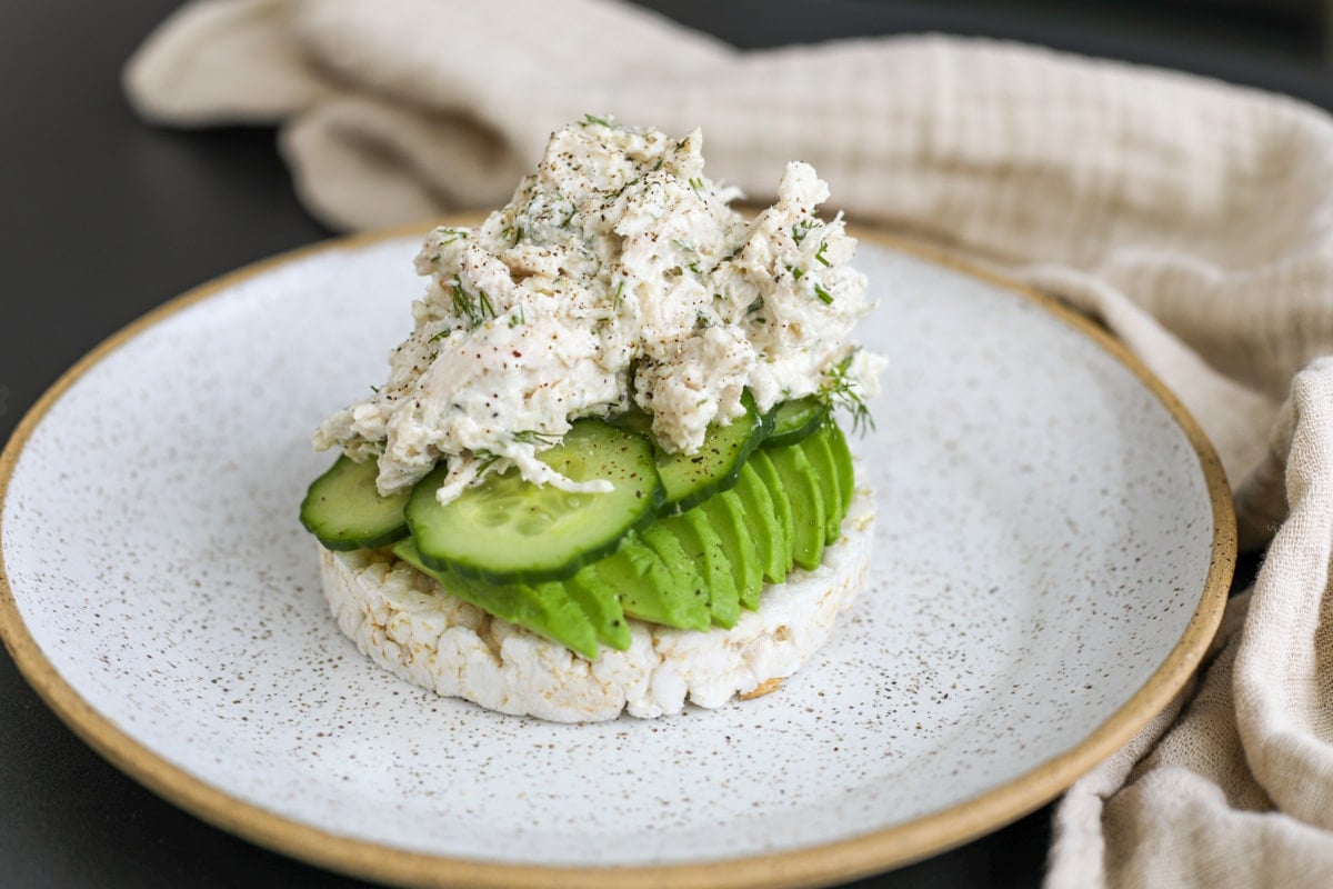 creamy tzatziki chicken salad piled high on a rice cake.