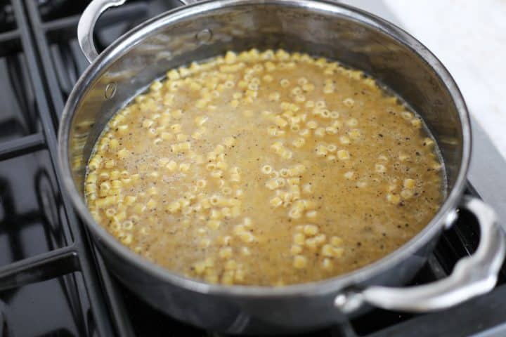 broth being added to the pasta and pepper.