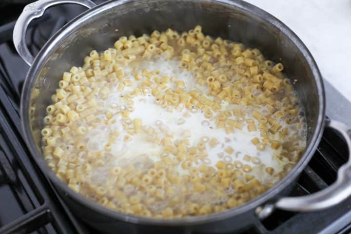 heavy cream being add to the sauce.