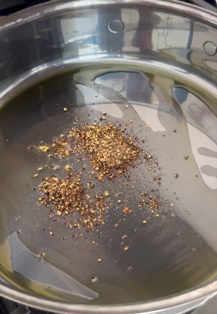 cracked black pepper in a pan with olive oil.