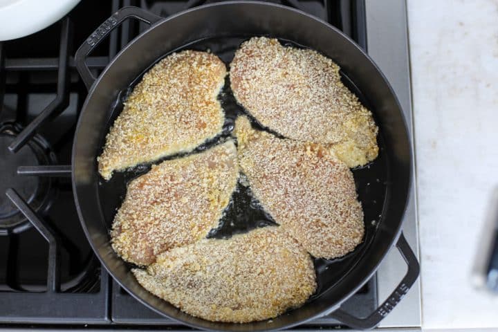 breaded cutlets in a pan with avocado oil frying. 
