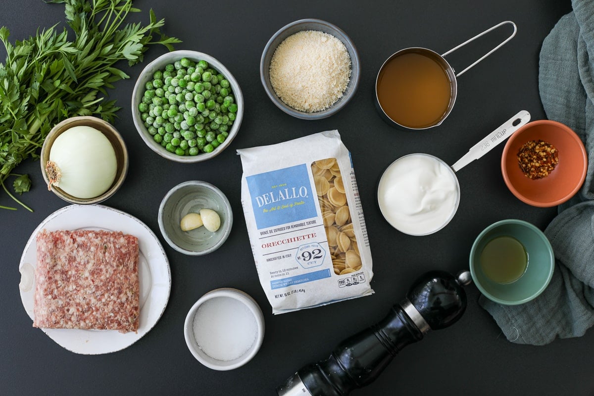 ingredients needed for creamy orecchiette sausage and pea pasta. 