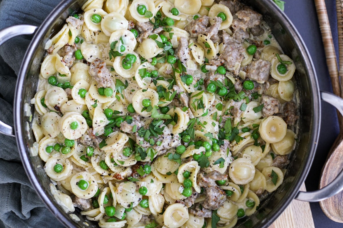 Creamy Orecchiette Sausage and Pea Pasta in a pan.