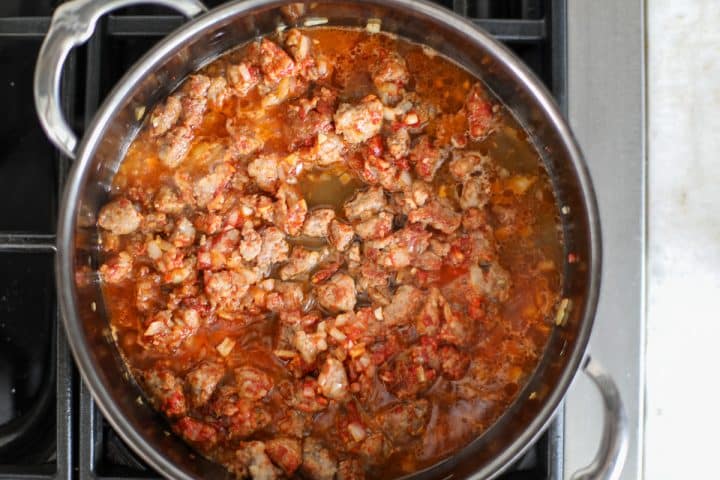 sausage, aromatics and tomato paste, deglazed with broth.