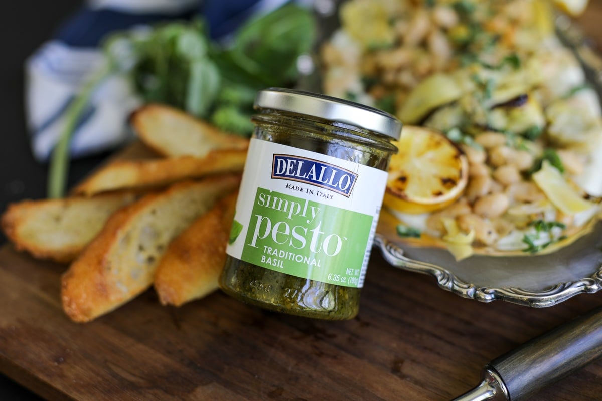 jarred pesto leaning up against a dish.