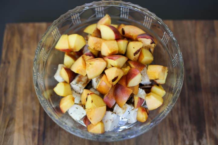 peaches in a bowl with chicken.