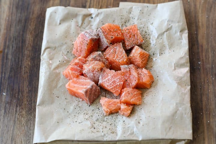 cubed salmon seasoned with salt and pepper.
