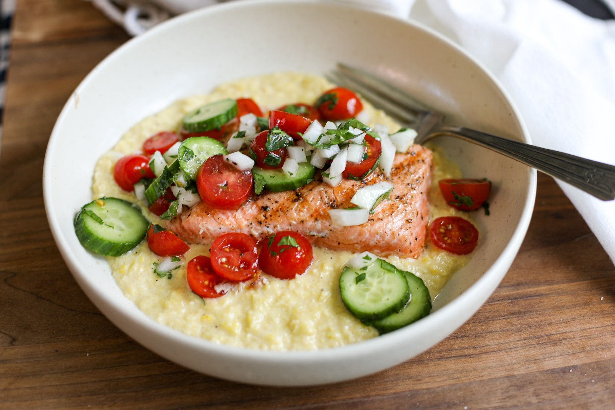 grilled salmon over corn puree with tomato salad.
