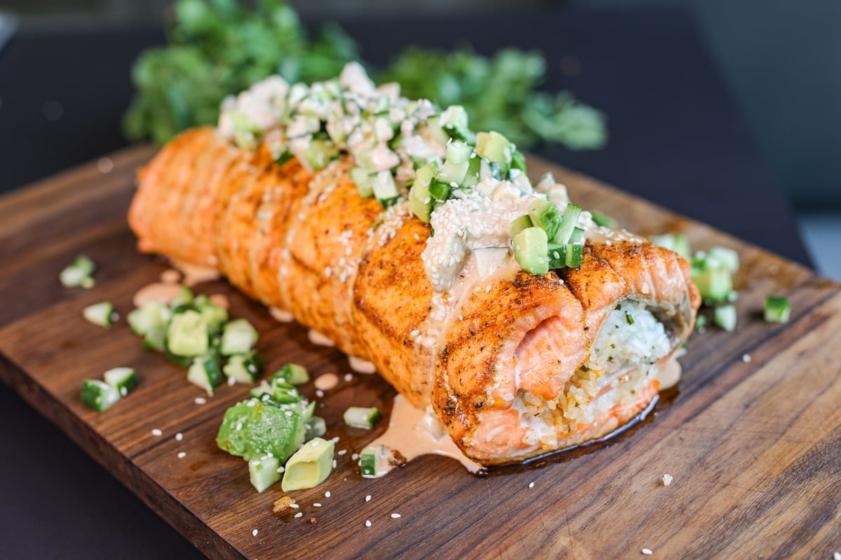 spicy baked salmon roll on a plate.