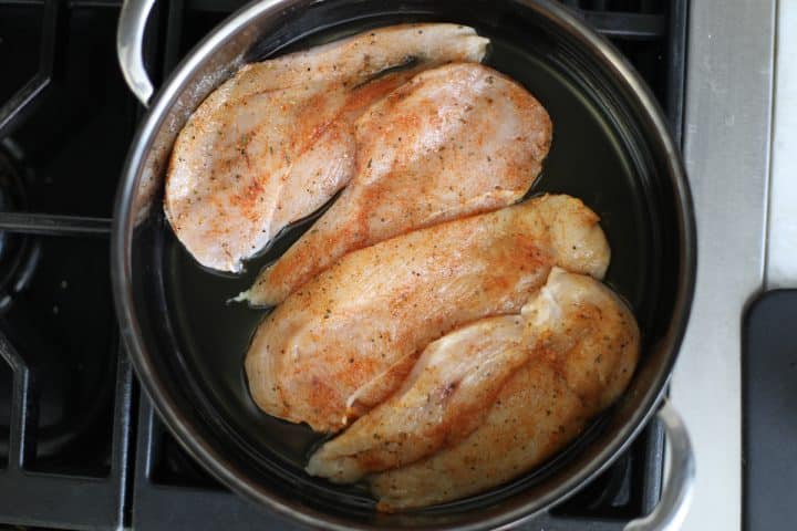 seasoned chicken in a pan.