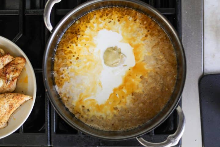 cream, onions, garlic and broth in a pan.