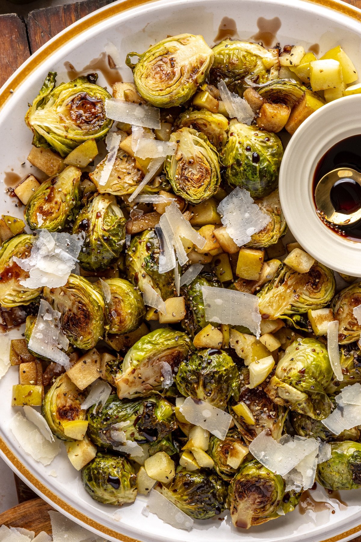 brussels sprouts on a plate with parmesan cheese and balsamic glaze.